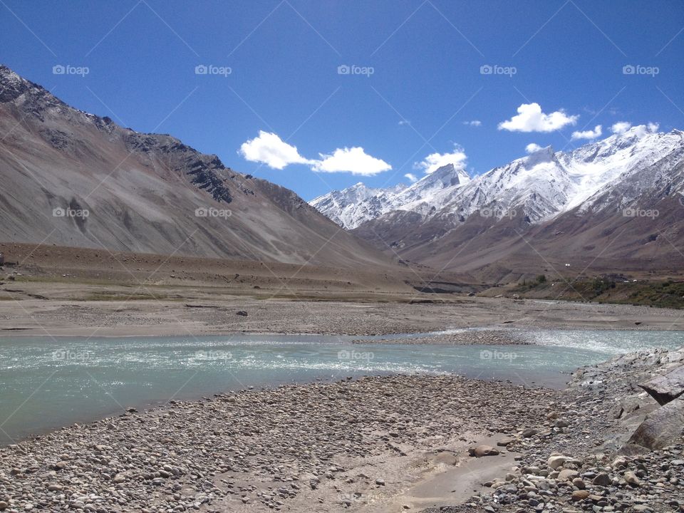 Mountains covered with snow, wild rivers and picturesque view in Himalayas of India