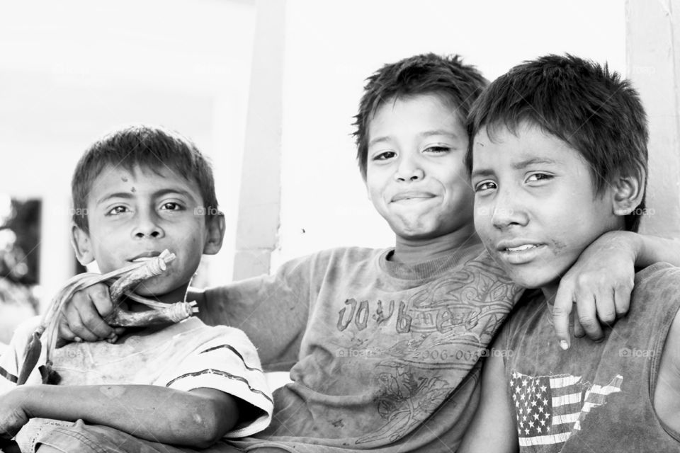 Boys will be boys. These boys shit a pigeon down with their sling shot and were hiding it behind their backs!