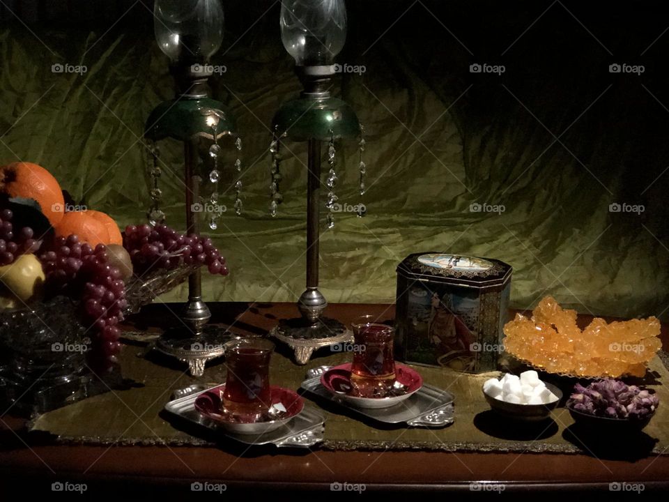 Iran has a rich culture of hospitality. Guests are welcome and considered as God's blessing. In this picture, I have tried to depict a scene called waiting for a guest. There are some items that many Iranians might find nostalgic, e.g., چای ایران.