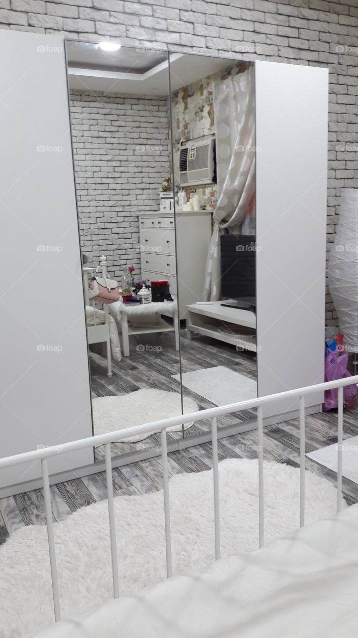 mirror's reflection of what's inside the cozy bedroom