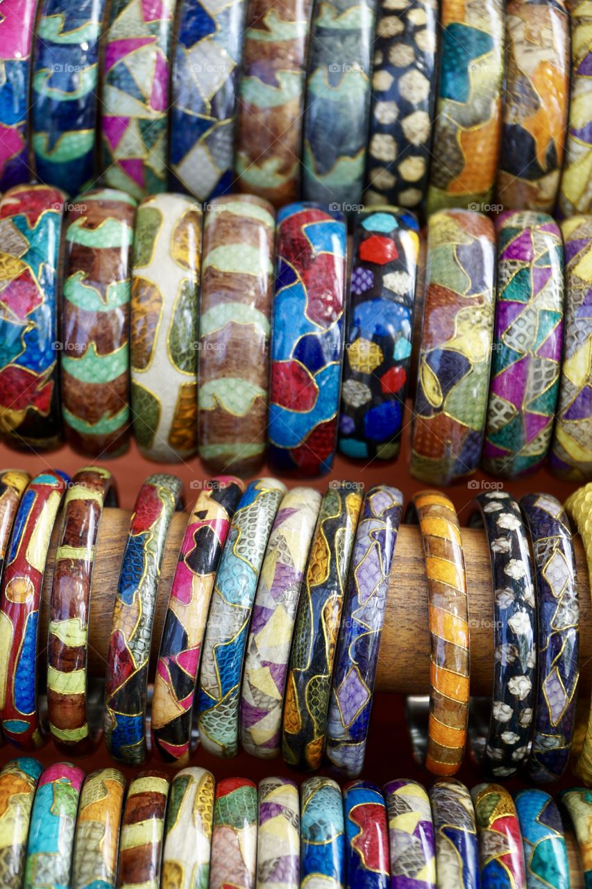 Rows of colourful wooden bangles