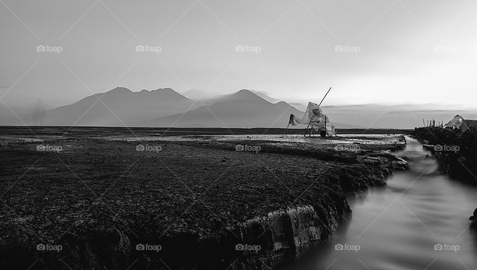 river flowing swiftly in desert with mountain view behind it