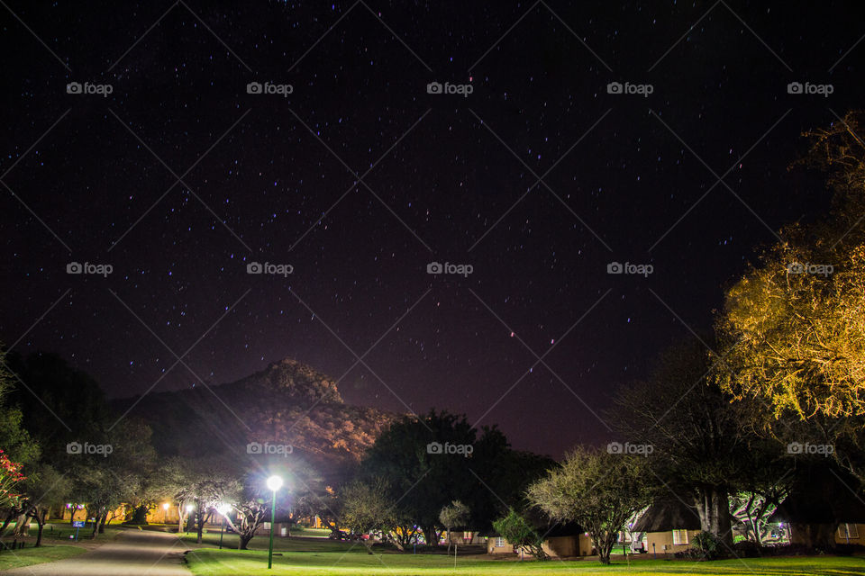 Lights and stars with a mountain in the background