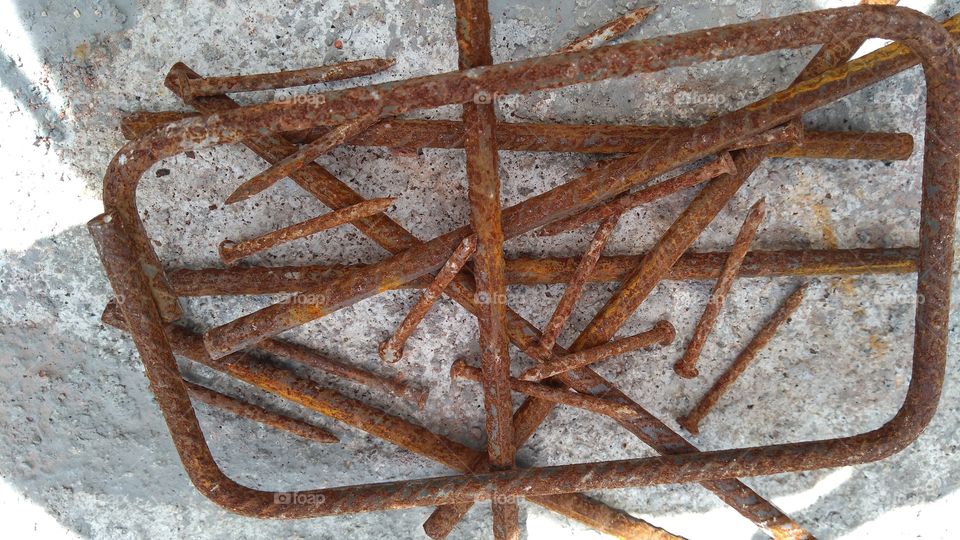 Elevated view of old grunge rod with nails
