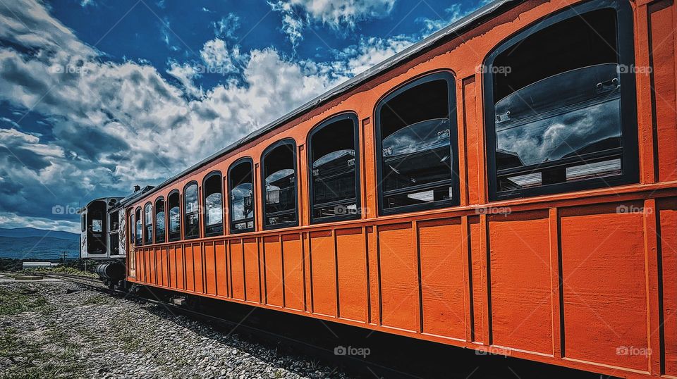 Orange train car, cog railway car, fun nostalgia train ride, train car ride up the mountain 