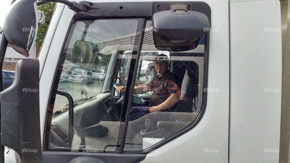 Man sitting in bus white bus