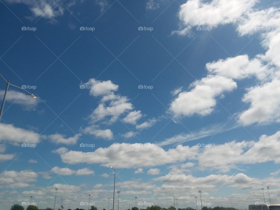 it looks like the sky curves and thats a center the way the couds circle it.