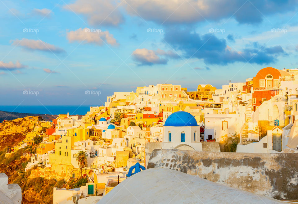 Santorini . Beautiful cityscape of Oia town on Santorini island with early morning sunlight, Mediterranean sea, Greece 