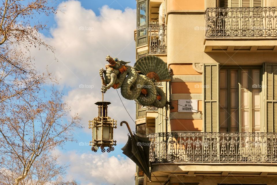 Chinese dragon on the corner of the facade of House of Umbrelas (Casa Bruno Cuadros), Barcelona, Spain