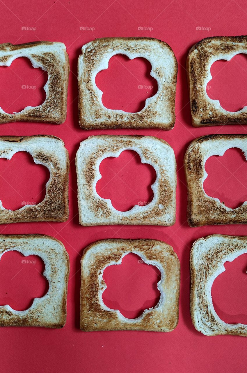 Toasters with cut out shapes in the form of flowers on a red background