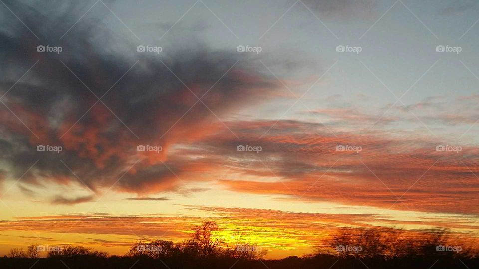 Scenic view of dramatic sky at sunset