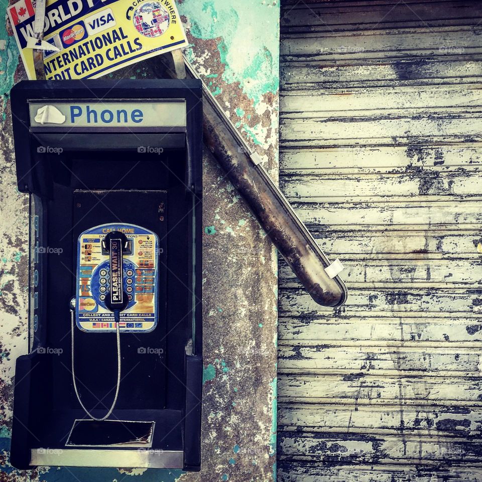 Old phone booth in the city, old phone, phone booth in the city, making a collect call, calling from a pay phone, days before cell phone, images of real phones, landline phones in the city 