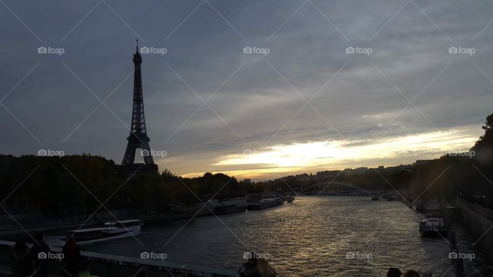 Eiffle tower, at dusk. illuminated,   Paris,  France, eu, Europe

The Seine (/seɪn/ sayn; French: La Seine, pronounced: [la sɛːn]) is a 777-kilometre (483 mi) long river and an important commercial waterway within the Paris Basin in the north of France. It rises at Source-Seine, 30 kilometres (19 mi) northwest of Dijon in northeastern France in the Langres plateau, flowing through Paris and into the English Channel at Le Havre (and Honfleur on the left bank).[1] It is navigable by ocean-going vessels as far as Rouen, 120 kilometres (75 mi) from the sea. Over 60 percent of its length, as far as Burgundy, is negotiable by commercial riverboats and nearly its whole length is available for recreational boating; excursion boats offer sightseeing tours of the Rive Droite and Rive Gauche within the city of Paris.

There are 37 bridges within Paris and dozens more spanning the river outside the city. Examples in Paris include the Pont Louis-Philippe and Pont Neuf, the latter of which dates back to 1607. Outside the city, examples include the Pont de Normandie, one of the longest cable-stayed bridges in the world, which links Le Havre to Honfleur.