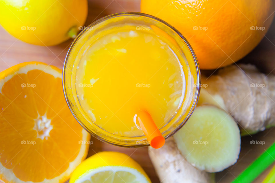 Ginger Shot with orange and citrus power Drink on daylight and Rustic background 