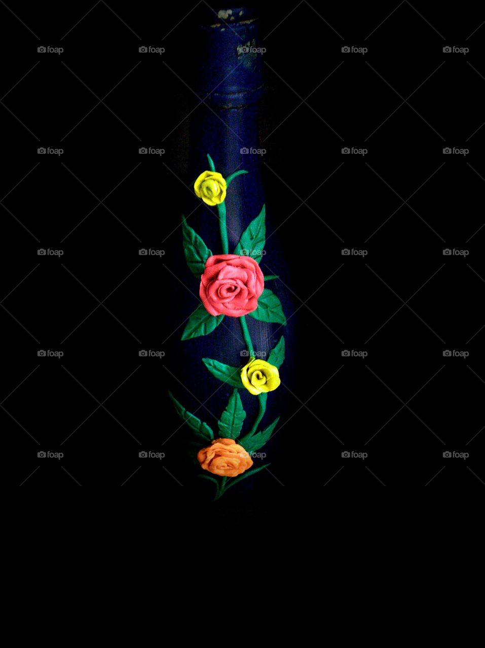 Decorating glass bottle using clay.