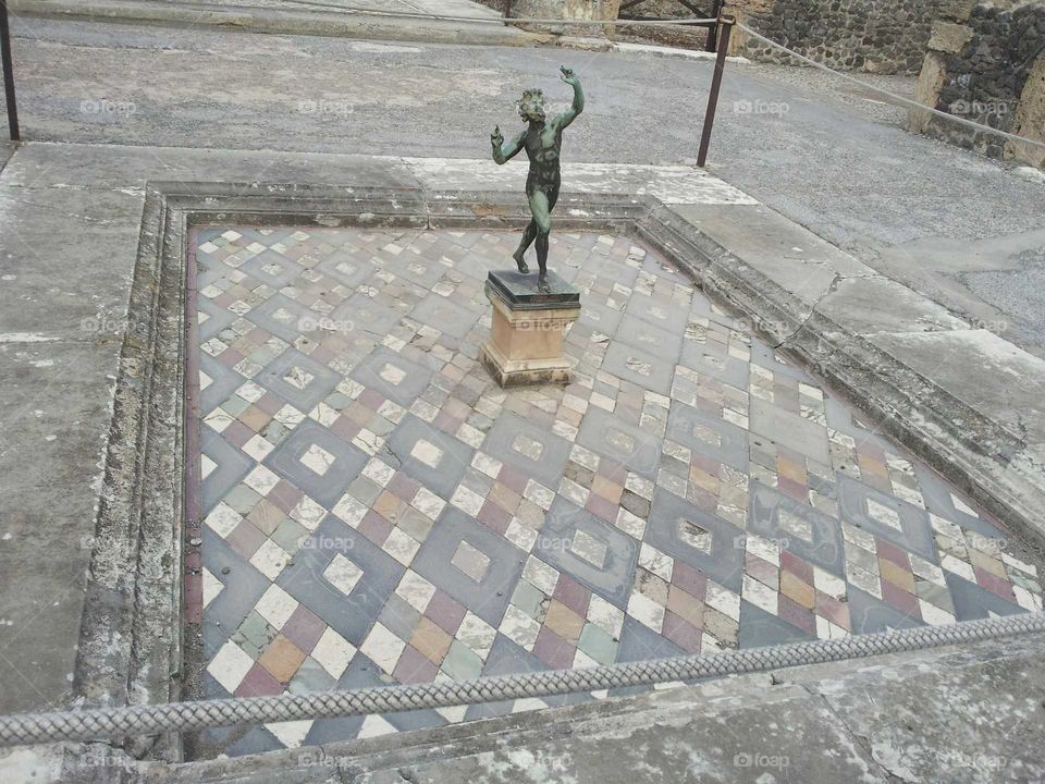 A statue remains in the ruins of Pompeii.
