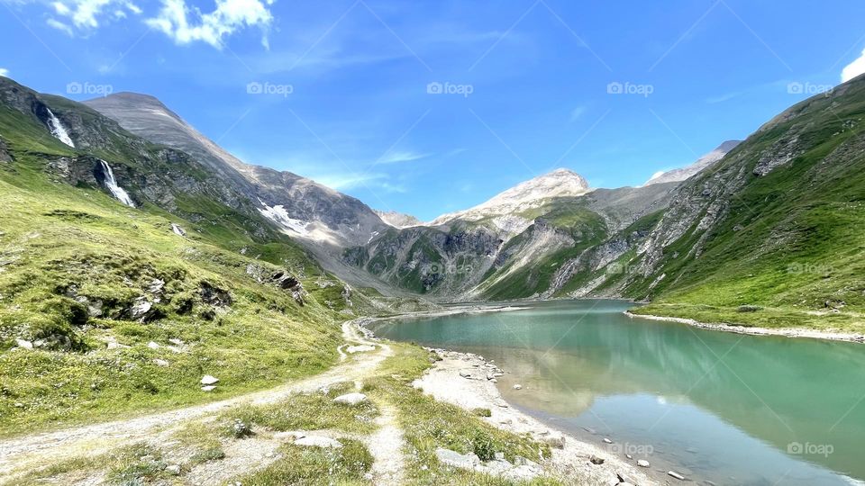 Beautiful landscape view of mountains, lake and waterfall at Heiligenblut in Großglockner Austria, perfect place to go hiking in 