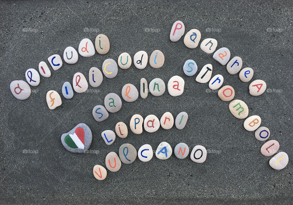 Aeolian islands names, souvenir on stone letters over black sand 