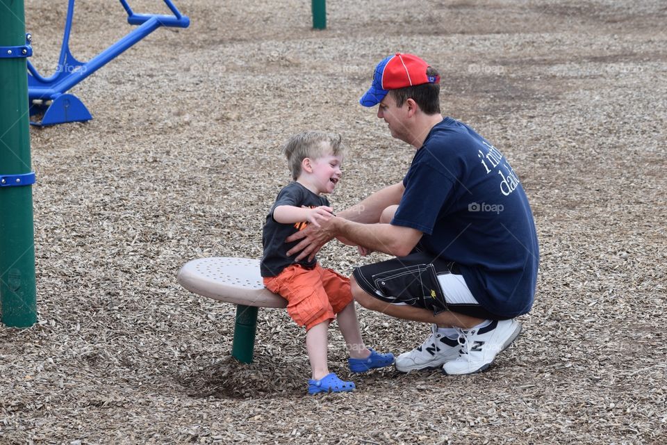 Dad and son playing at the park