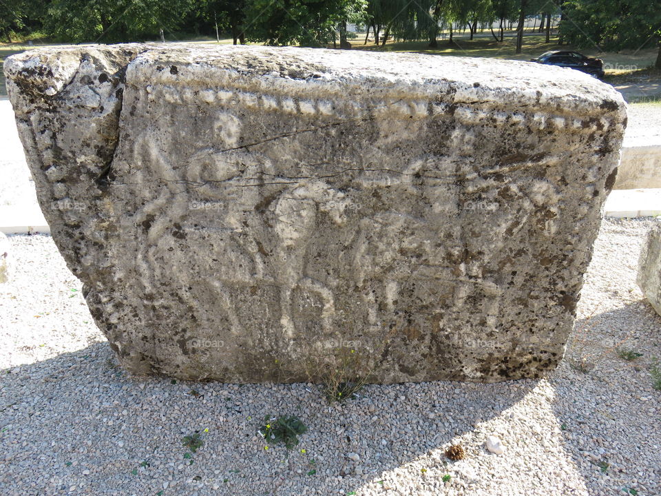 Medieval stone slab with carvings of horsemen