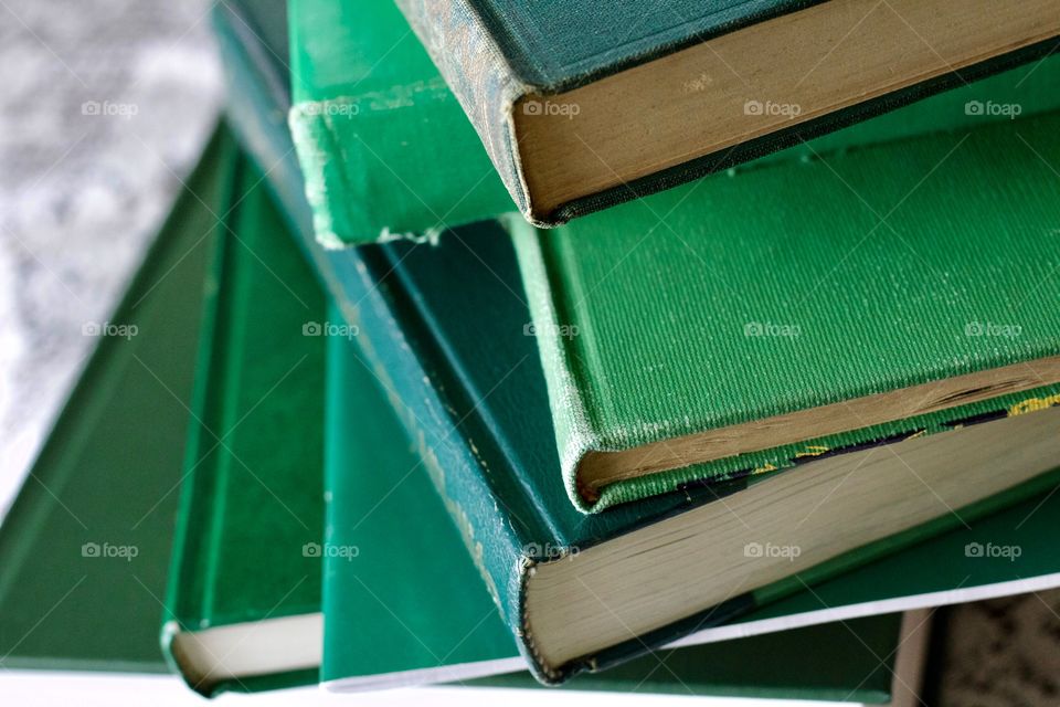 Green Color Story - stacked books with various shades of green covers 