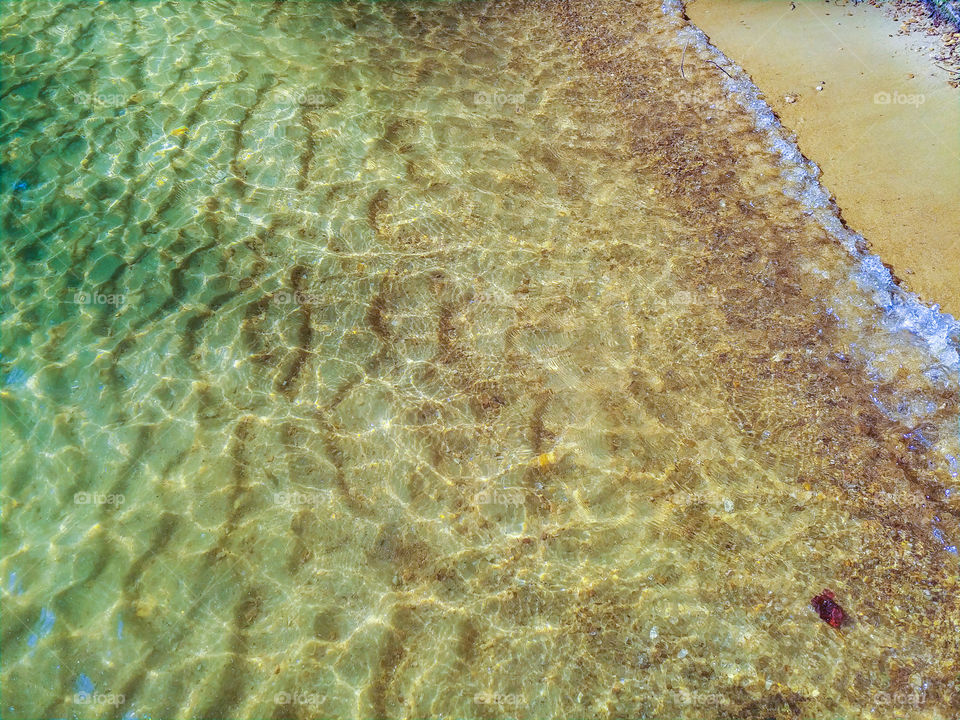 ripples in the sand caused by small waves. Clear water. paradise