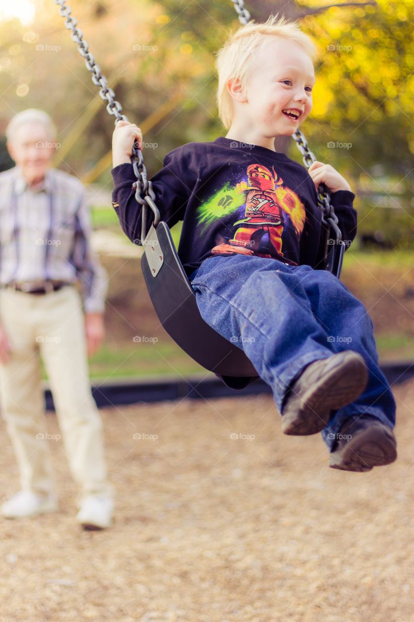 Swinging. My son at the park with family
