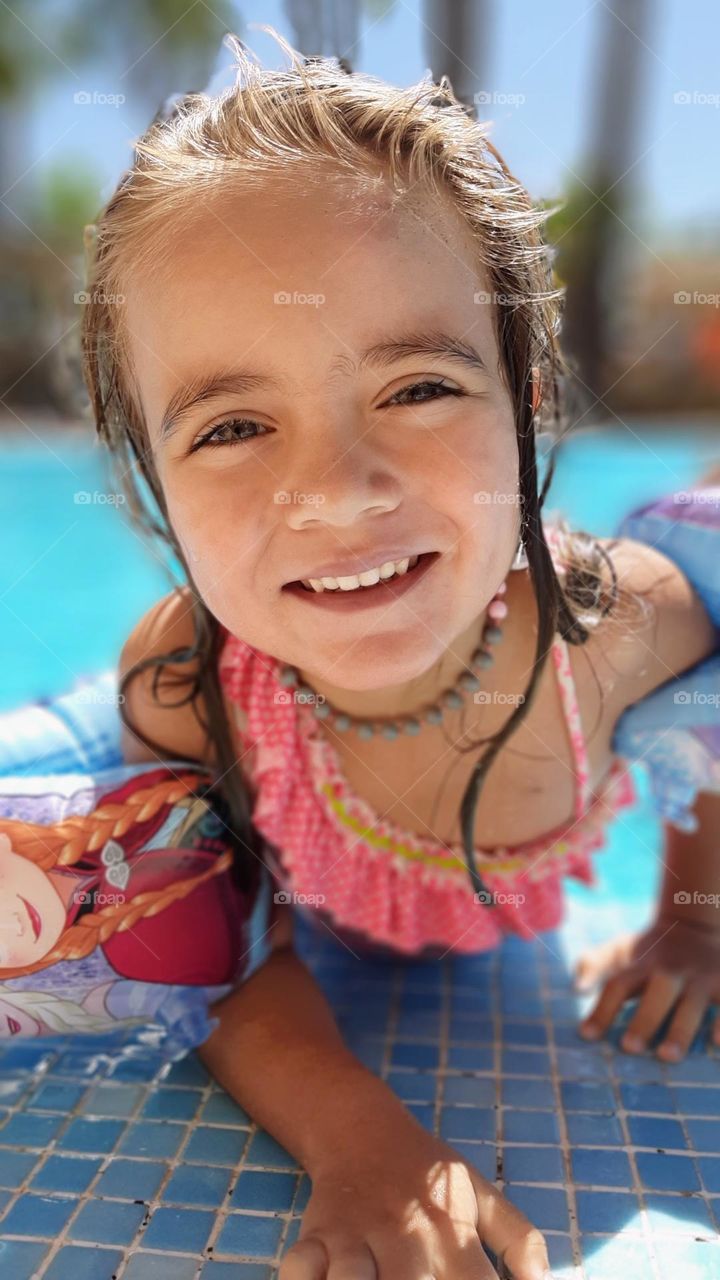 Little girl coming out of the swimming pool