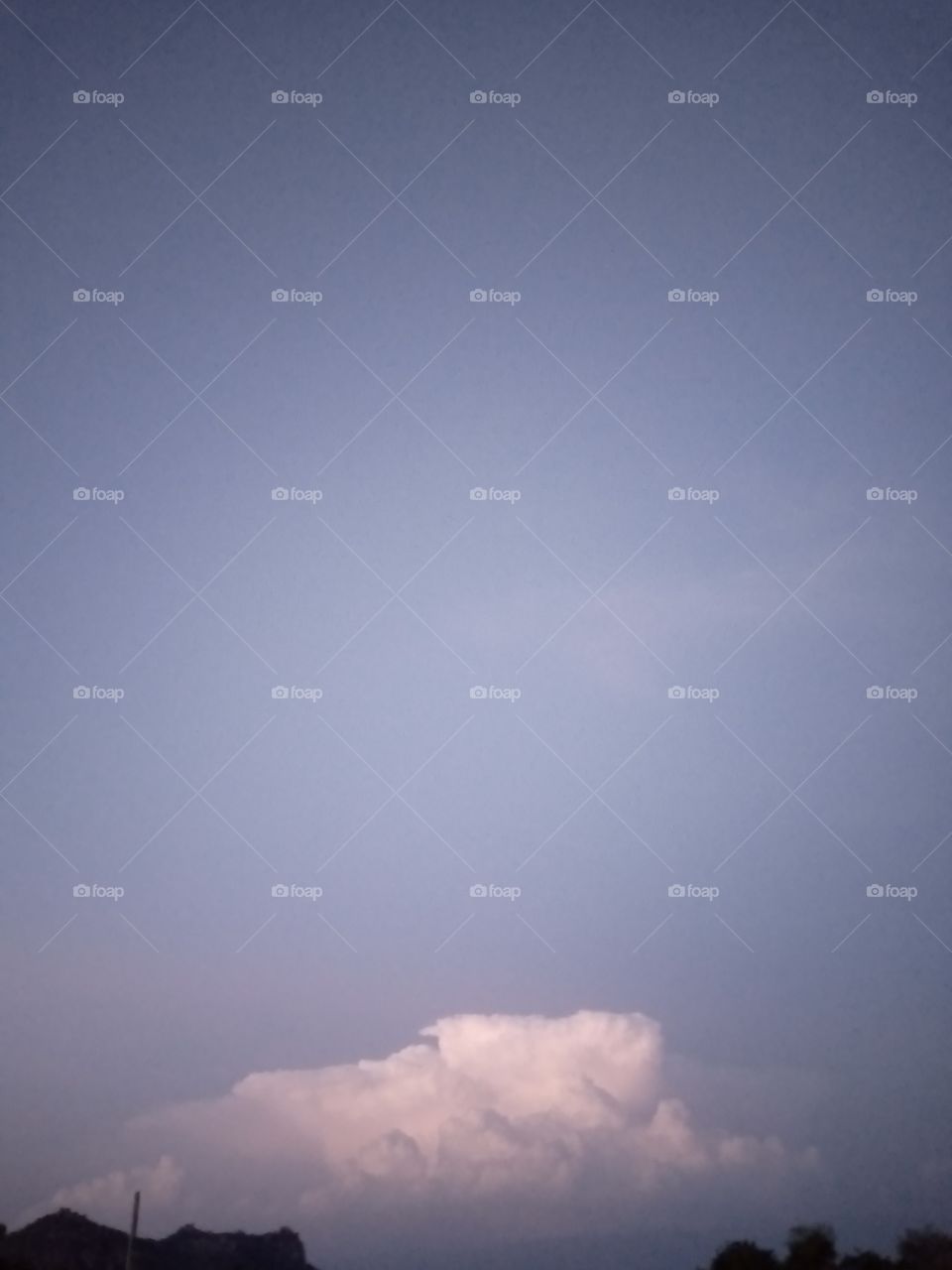 A cloudy sky with blue background and white forms