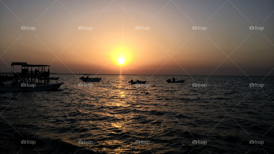 Beach sunset with local fishermen boats