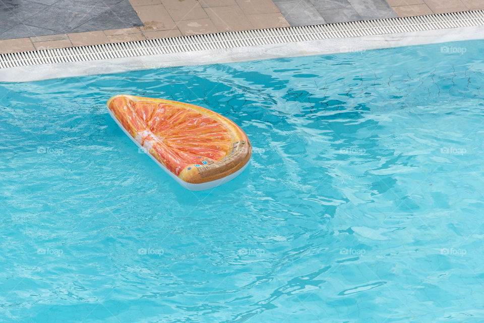 Water in the pool and orange slice inflatable pool float