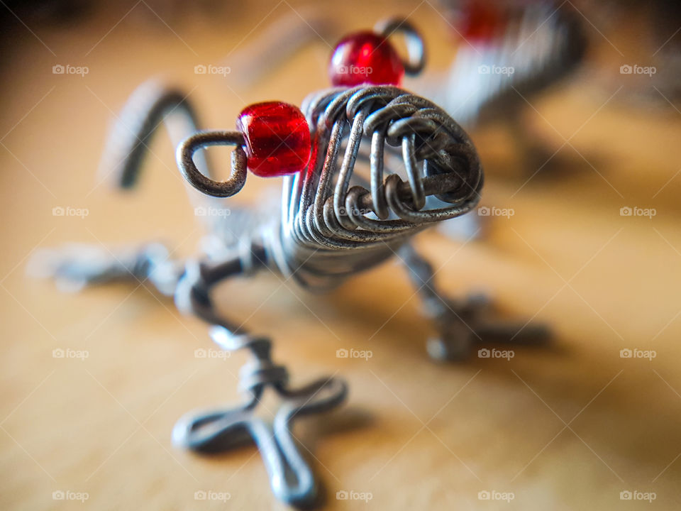 metal lizzard with beed eyes close up