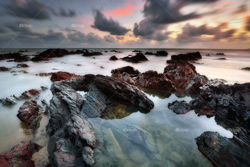 Sunrise over the rocky beach