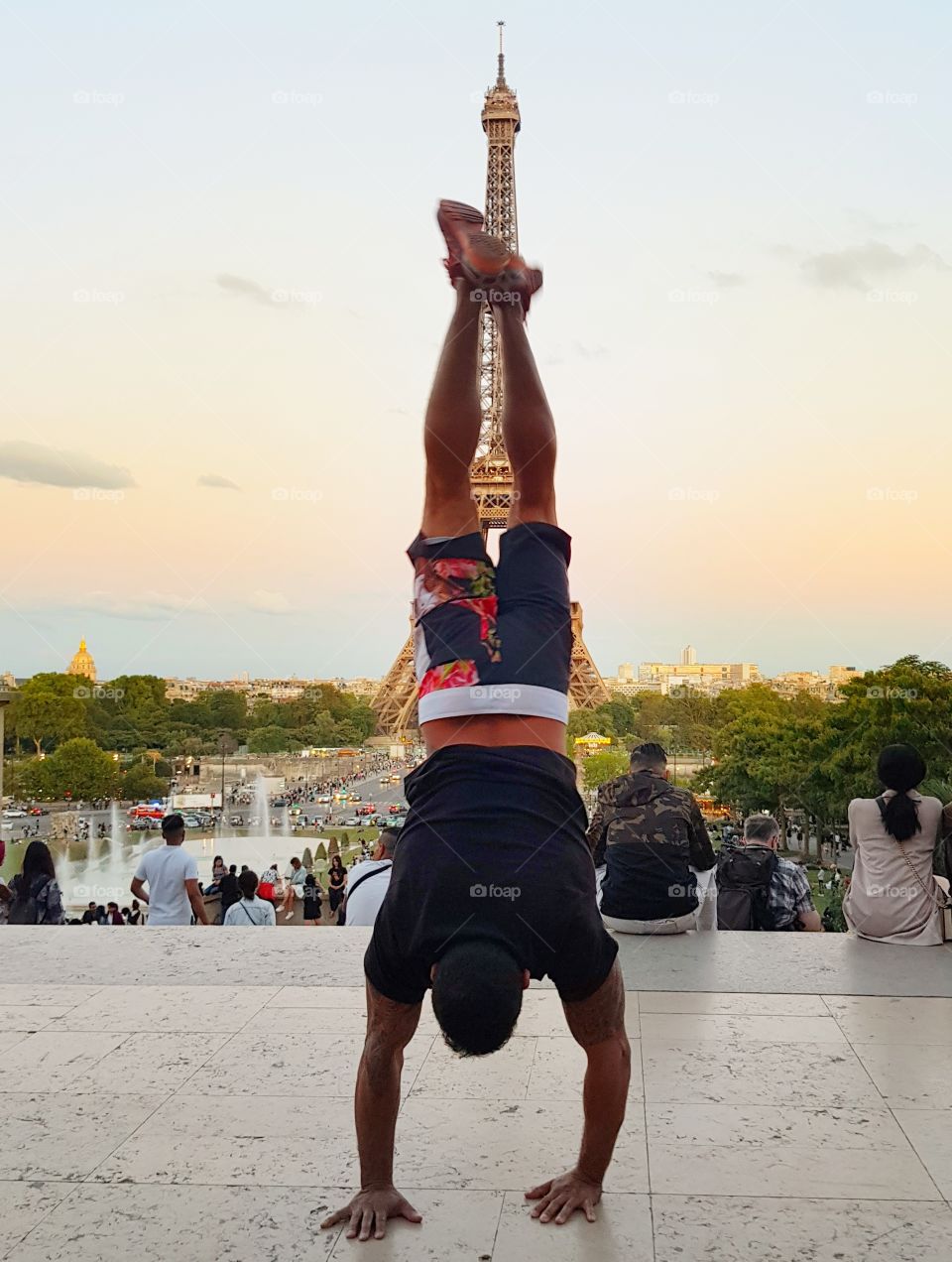 head down in front of the Eiffel Tower