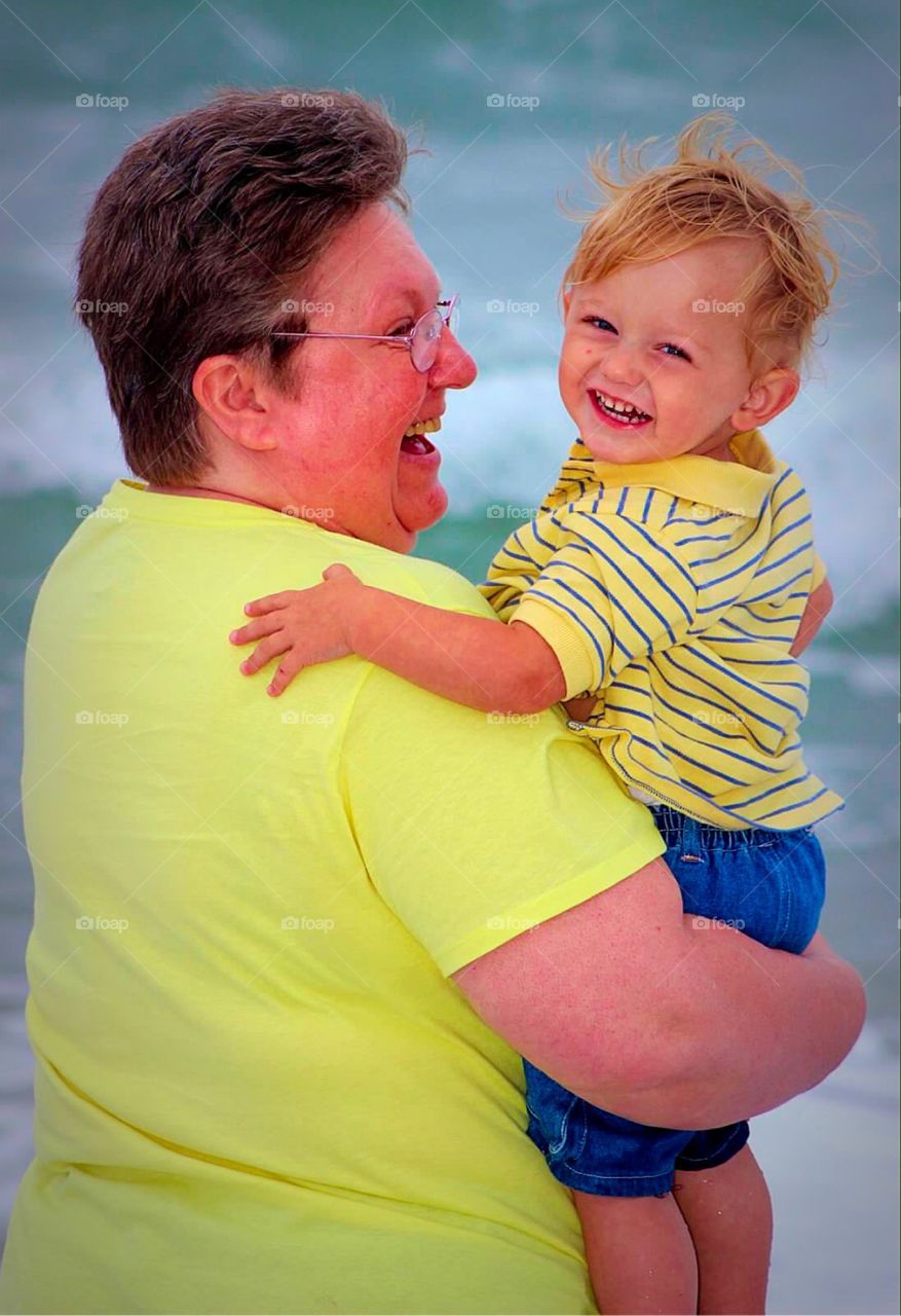 Mother carrying her smiling boy