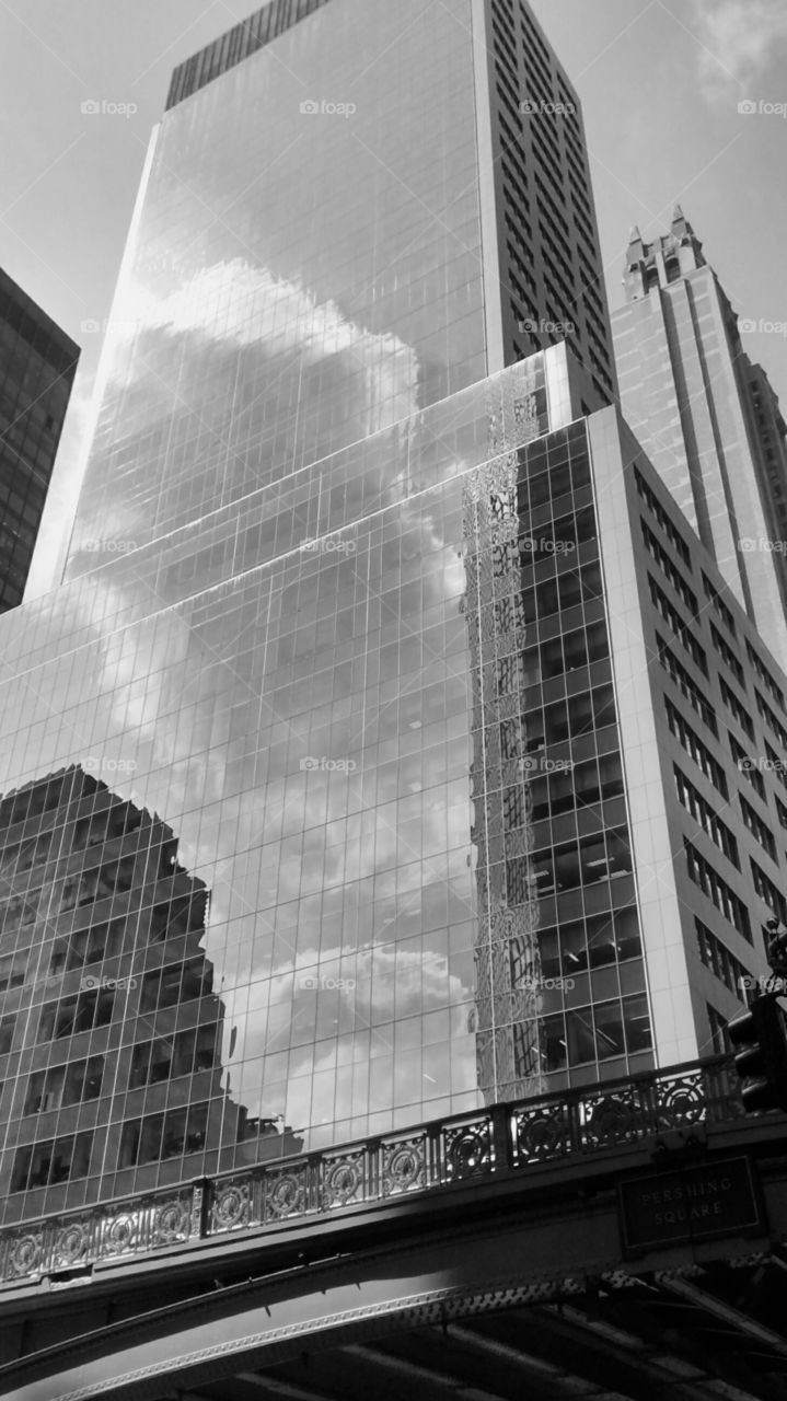Sky and cloud reflected in building