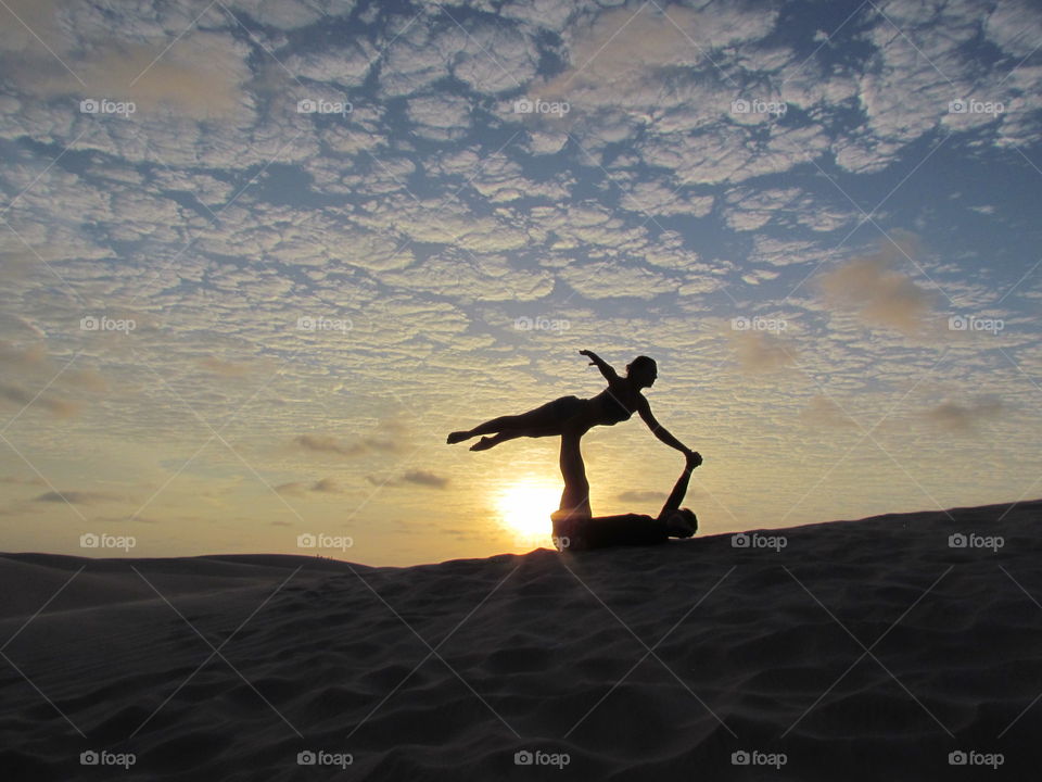 Acroyoga on the sunset at Lençóis Maranhenses National Park