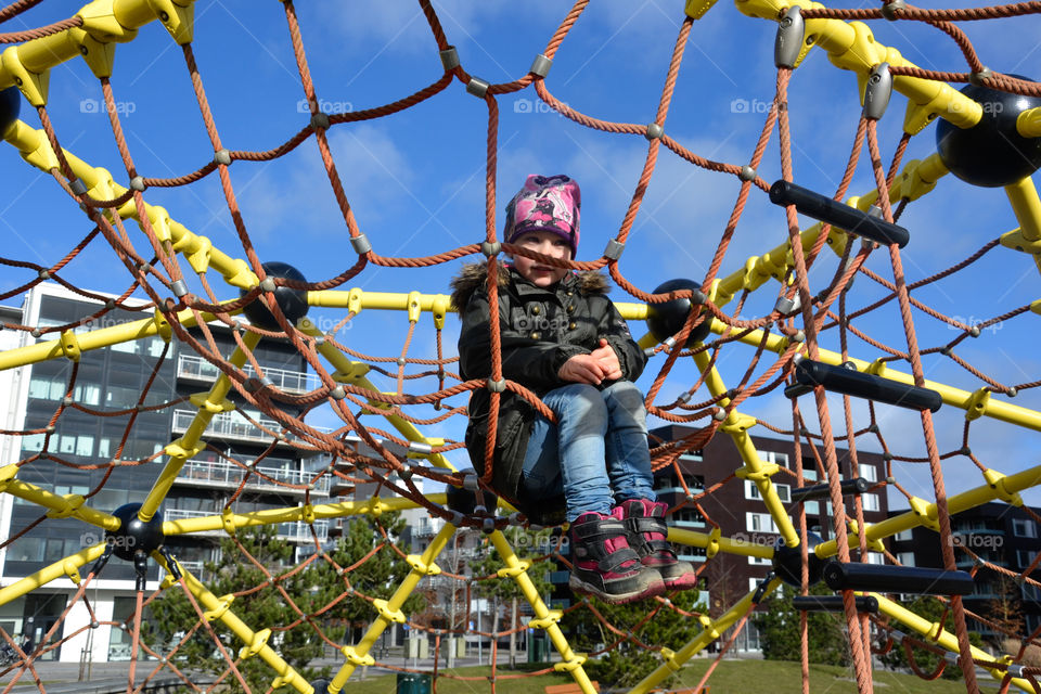 Young girl is playing at the playground at west harbour in Malmö Sweden.