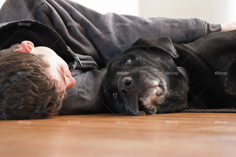 Teenage boy relaxing with his dog