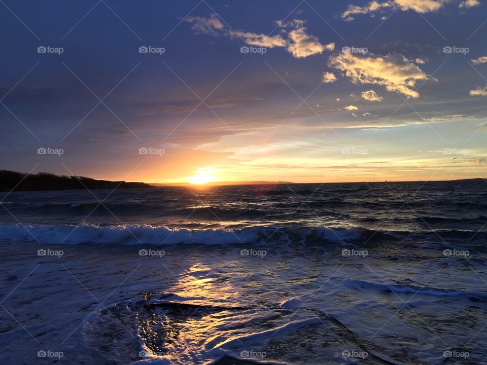 Scenic view of beach at sunrise