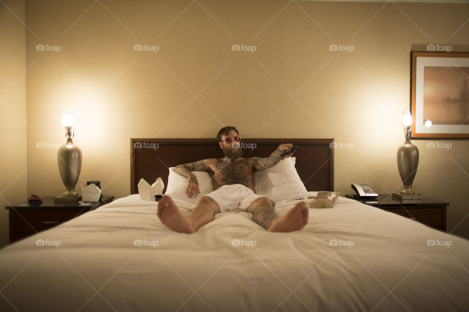 Hipster Lounging in Hotel Room