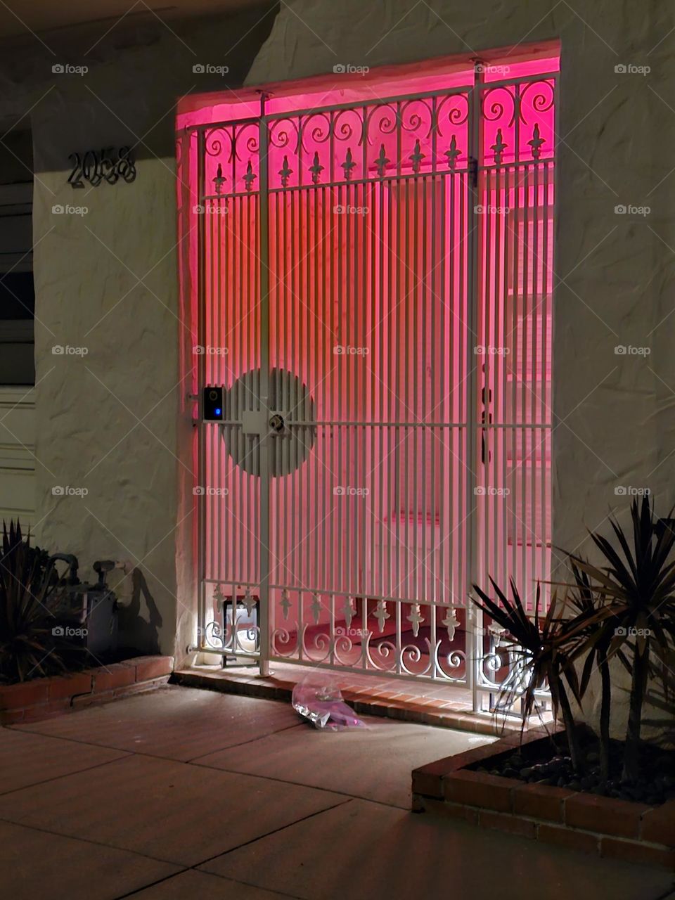 pink ombre lights illuminate the entrance to a home in San Francisco CA at night