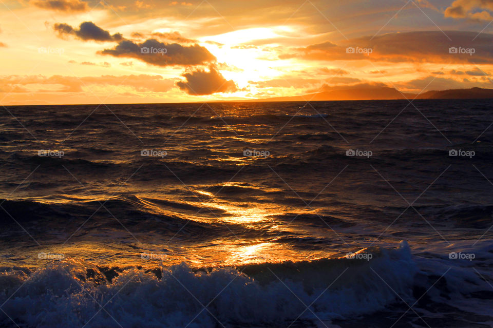 OCEAN:Some sunrise shots of the ocean on a windy Pacific Northwest morning. The high tide created frothy waves breaking on the shore. There were some clouds but the sun shone through creating beautiful colour in the sky and sea.