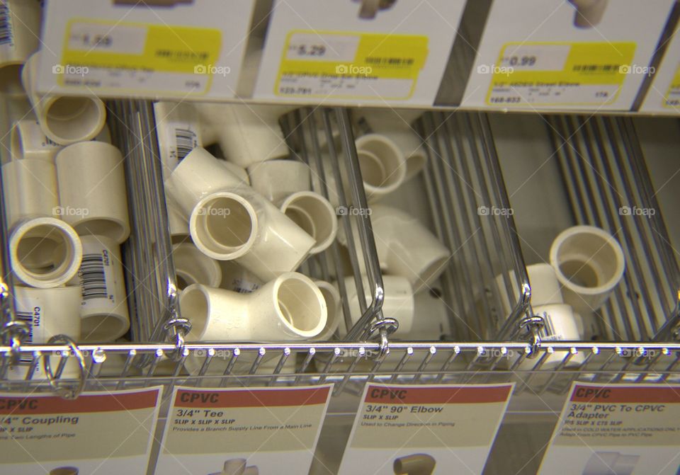 Bins of Small Plastic PVC Elbows