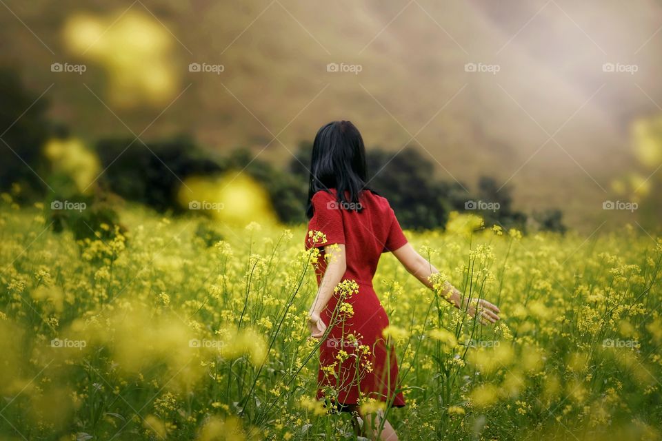 Rear view of woman standing in field