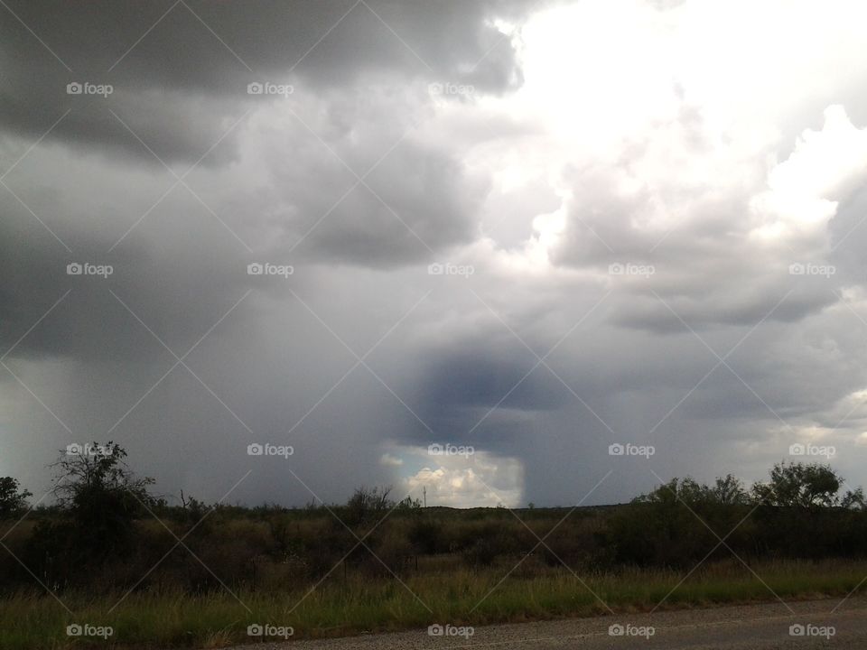 Unique Cloud Formation. Squared Door-like Shape in a Dark, Overcast Sky.  Bright Sun Shines Out of Upper Corner