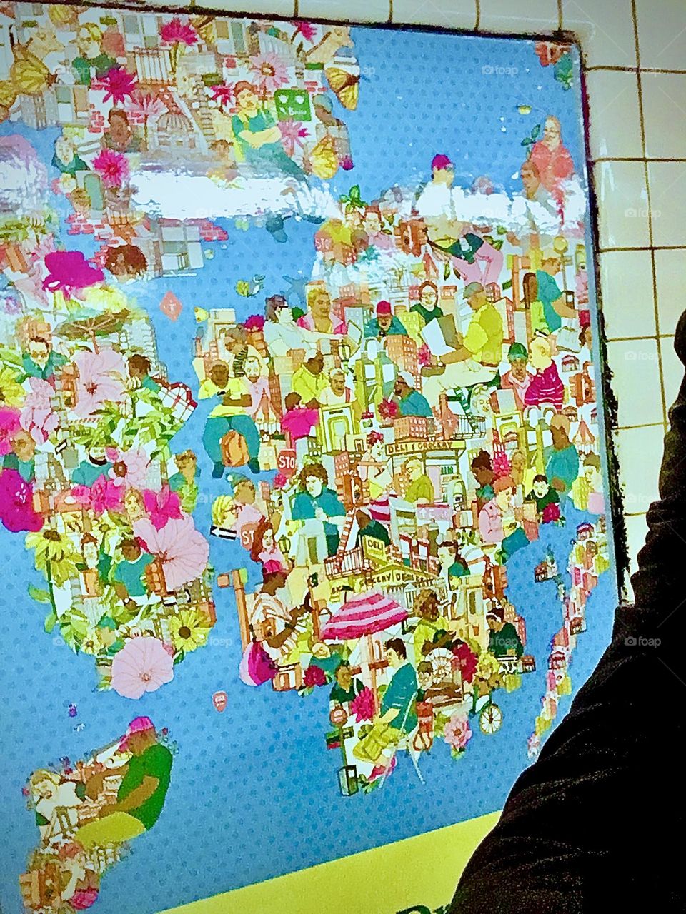 I, „Petra Schiller“ am standing on the far right with only the sleeve of my black leather jacket visible in the „Van Alst Av 21st St“ „G“ train station next to a colorful art poster displayed on the wall. 2020. Hypnotic Productions