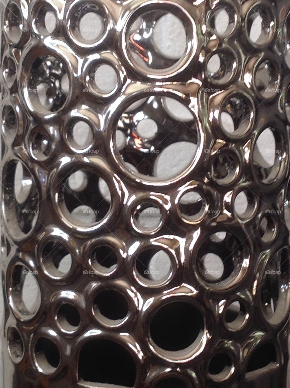 A metal canister with holes.