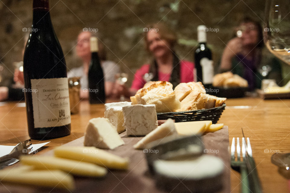 Dinner in a wine cellar. A group of friends enjoying dinner and a wine tasting in Paris, France.