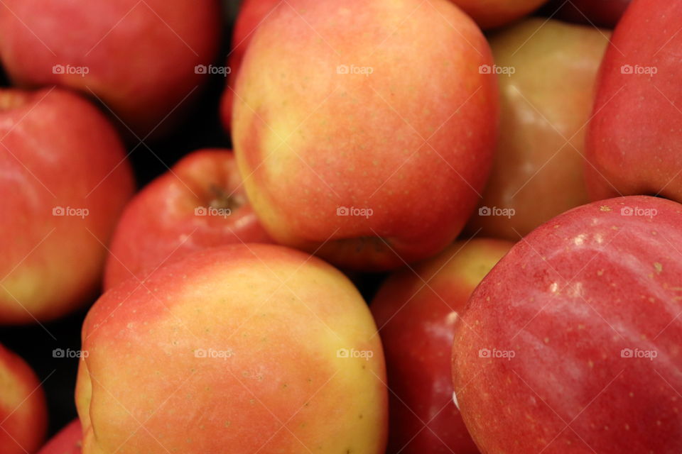 Gala apples up close in a display case at a market. 
